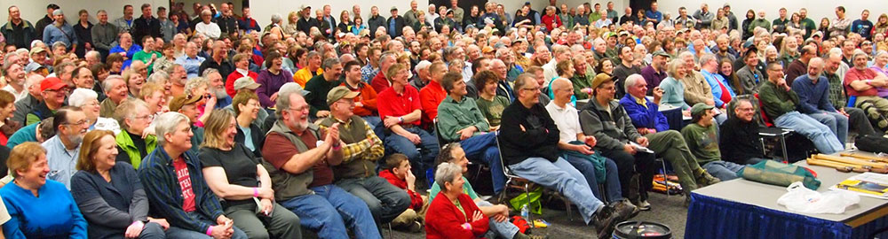 Audience filling a presentation room at Canoecopia
